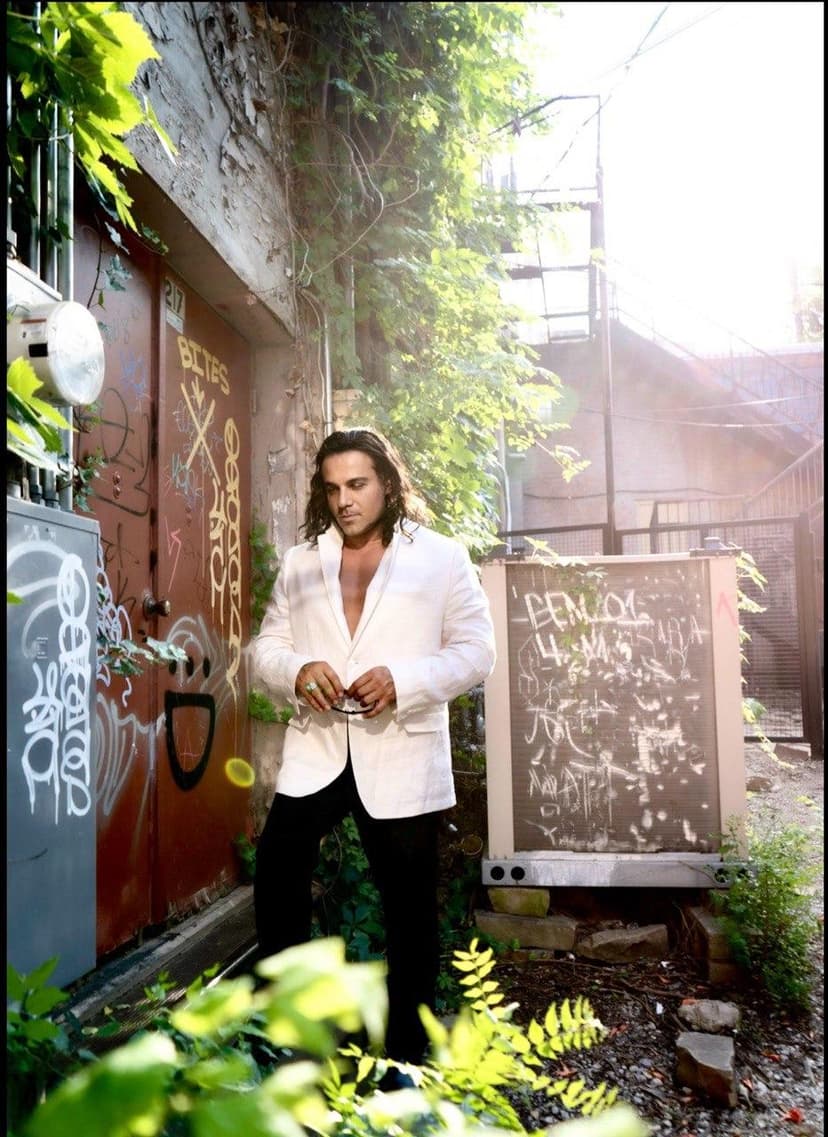 Dr. Ray in white blazer, urban alley photoshoot